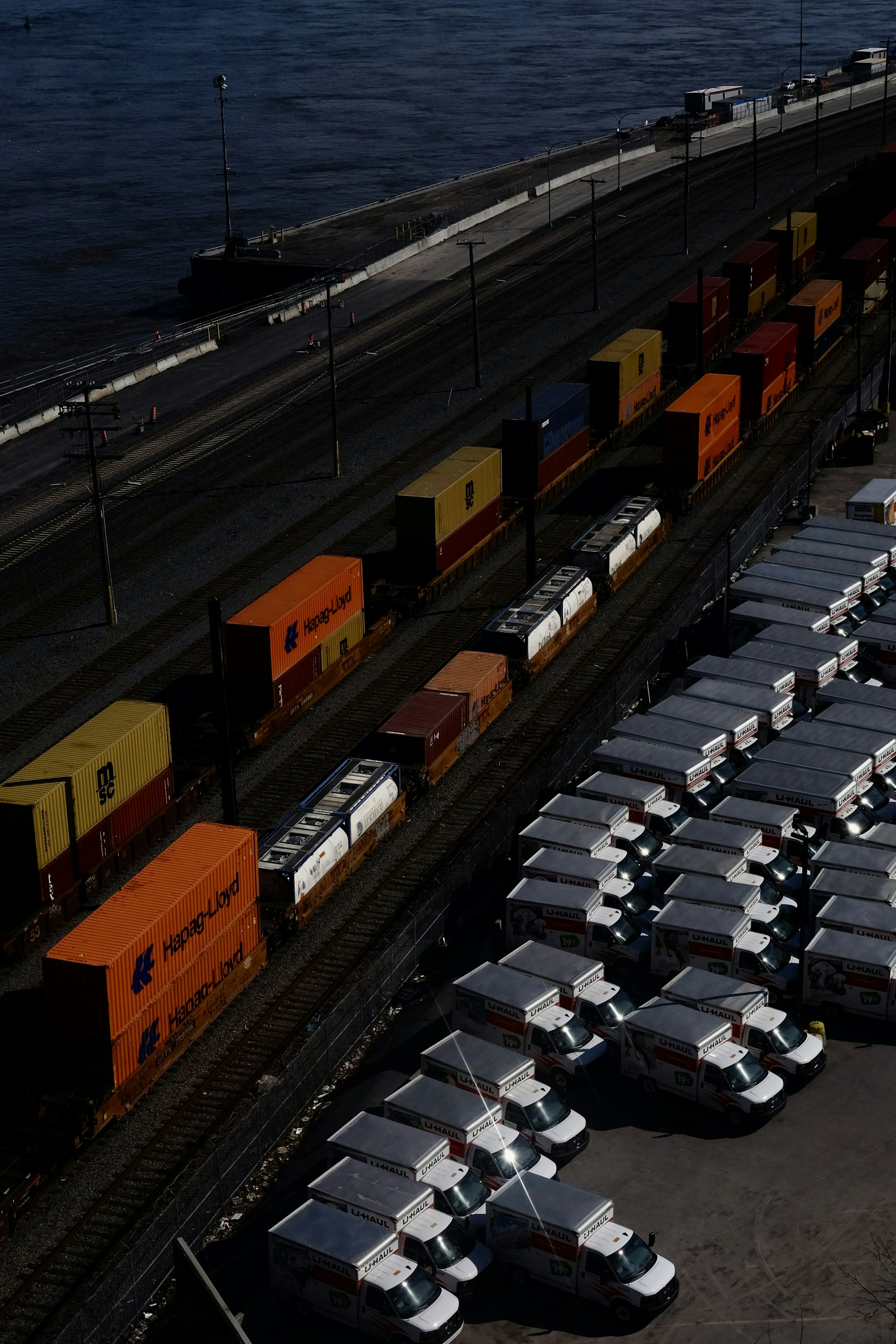 Real cargo containers, trains, and trucks operating at a port