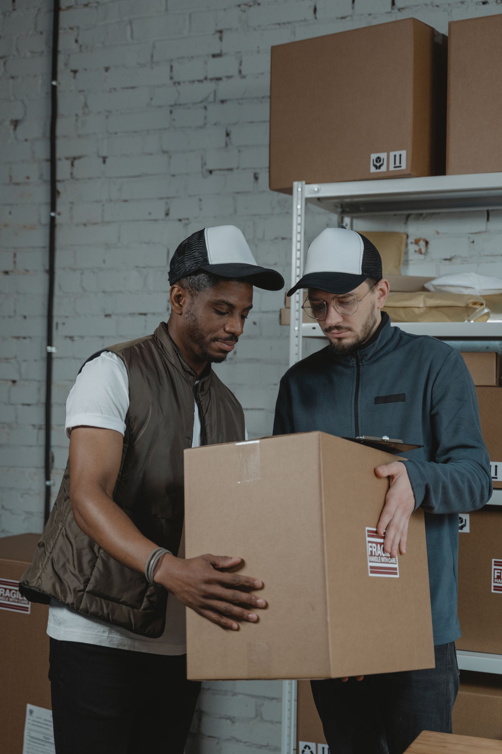 Warehouse team reviewing shipment documentation on boxed cargo