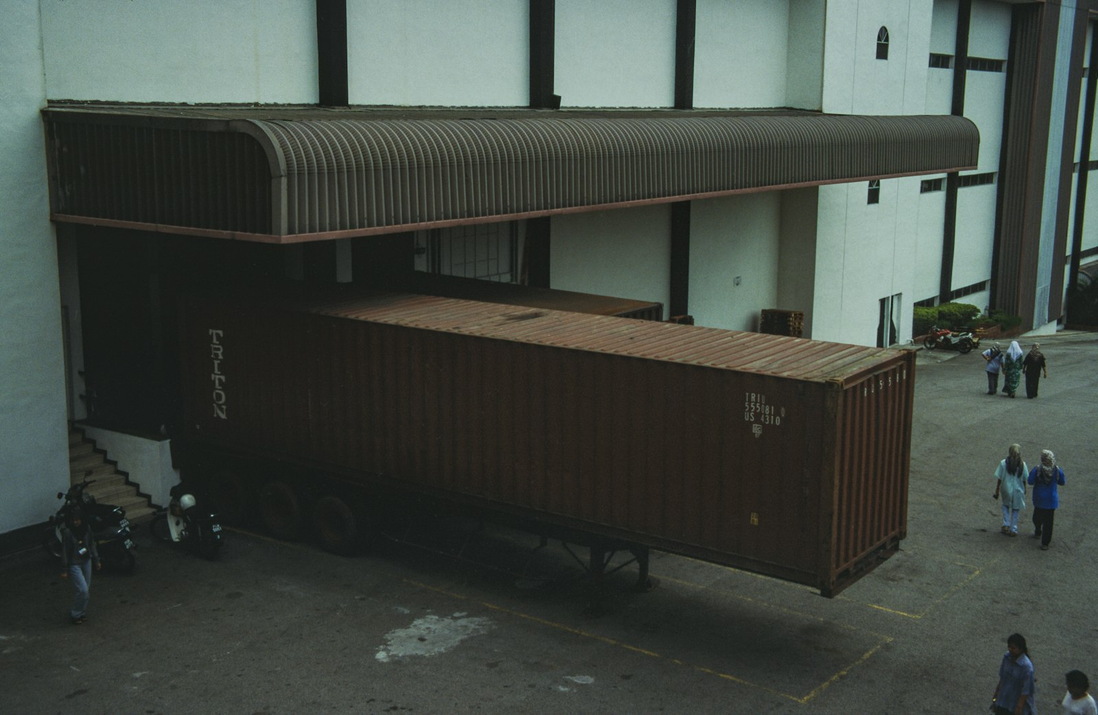 Real truck backed into a warehouse loading dock for freight handling